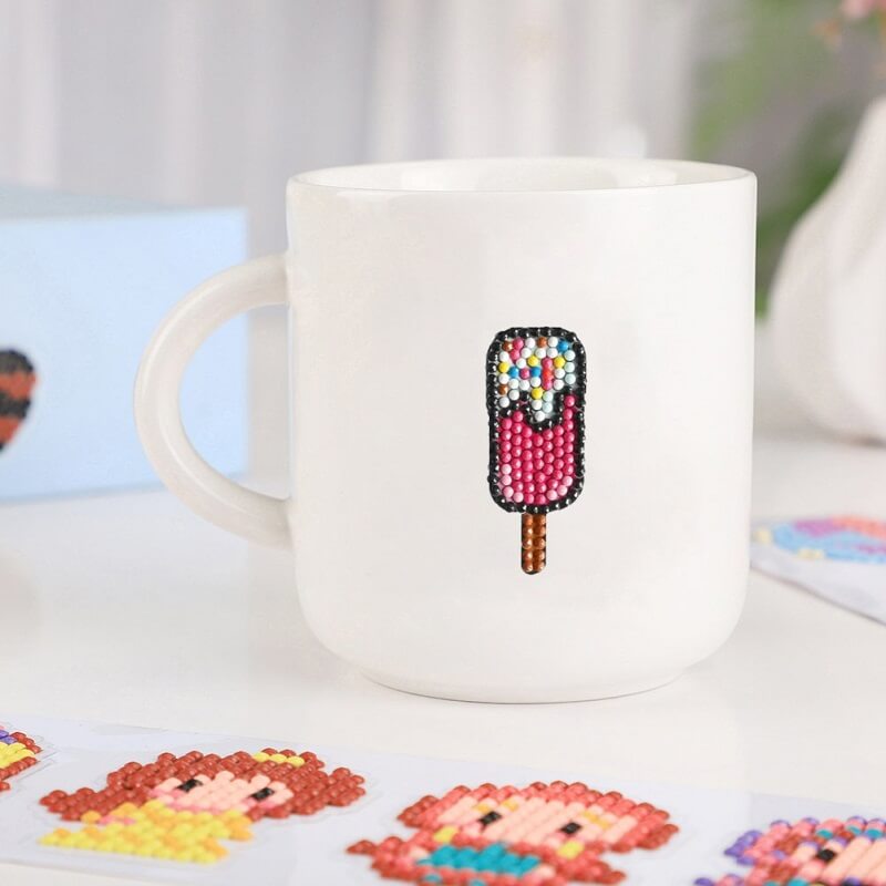 a white cup has an ice cream pattern diamond painting sticker on it